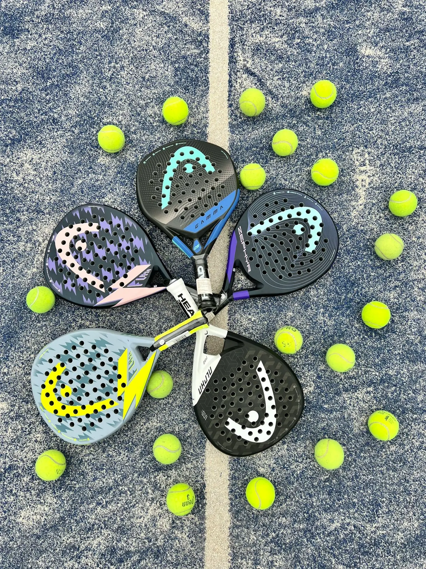 a pair of tennis rackets and balls on the ground